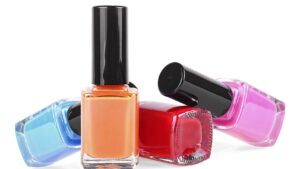 Bottles of colored nail polish isolated on a white background